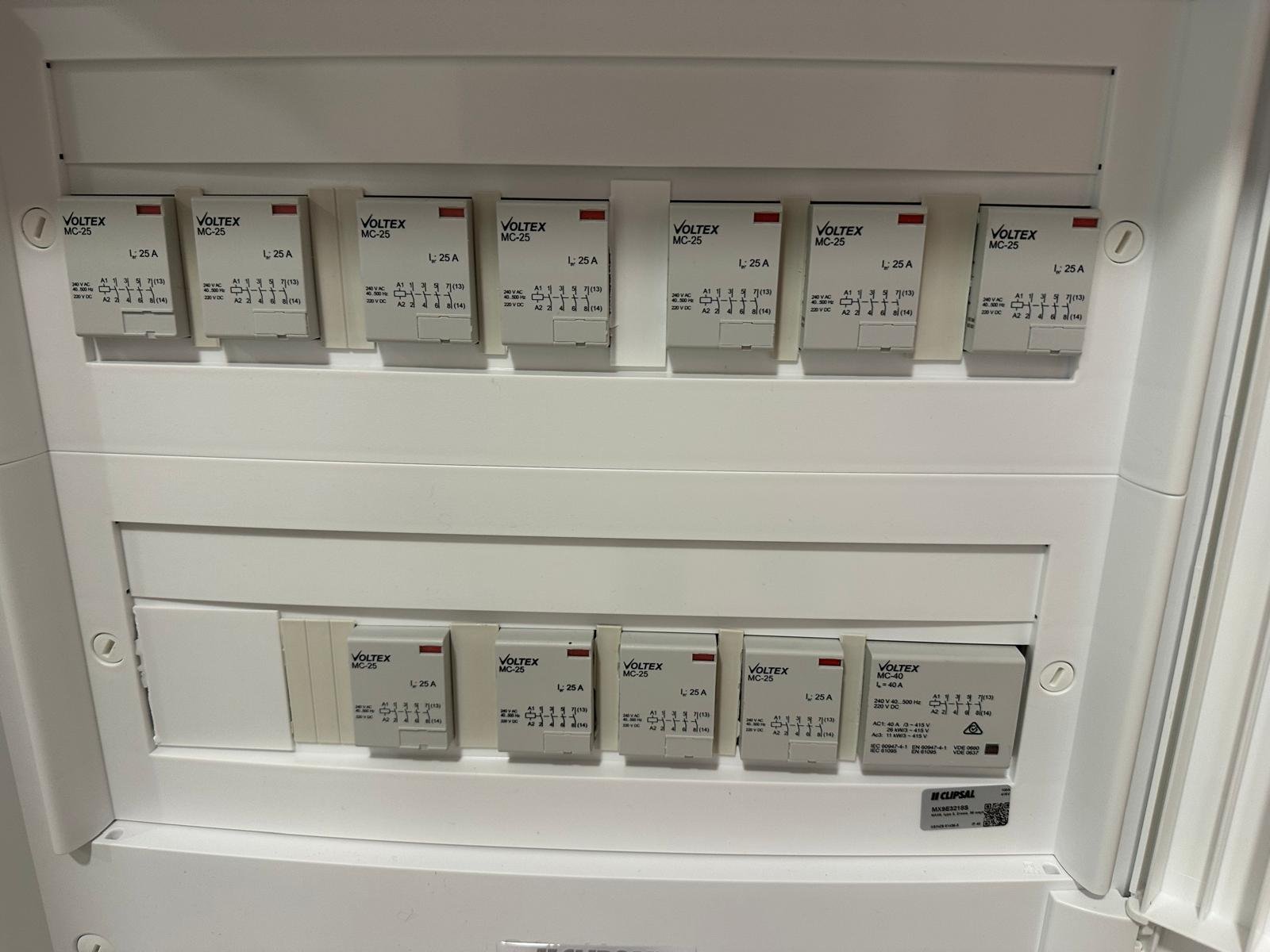Residential electrical control board with neatly aligned contactors and protective devices