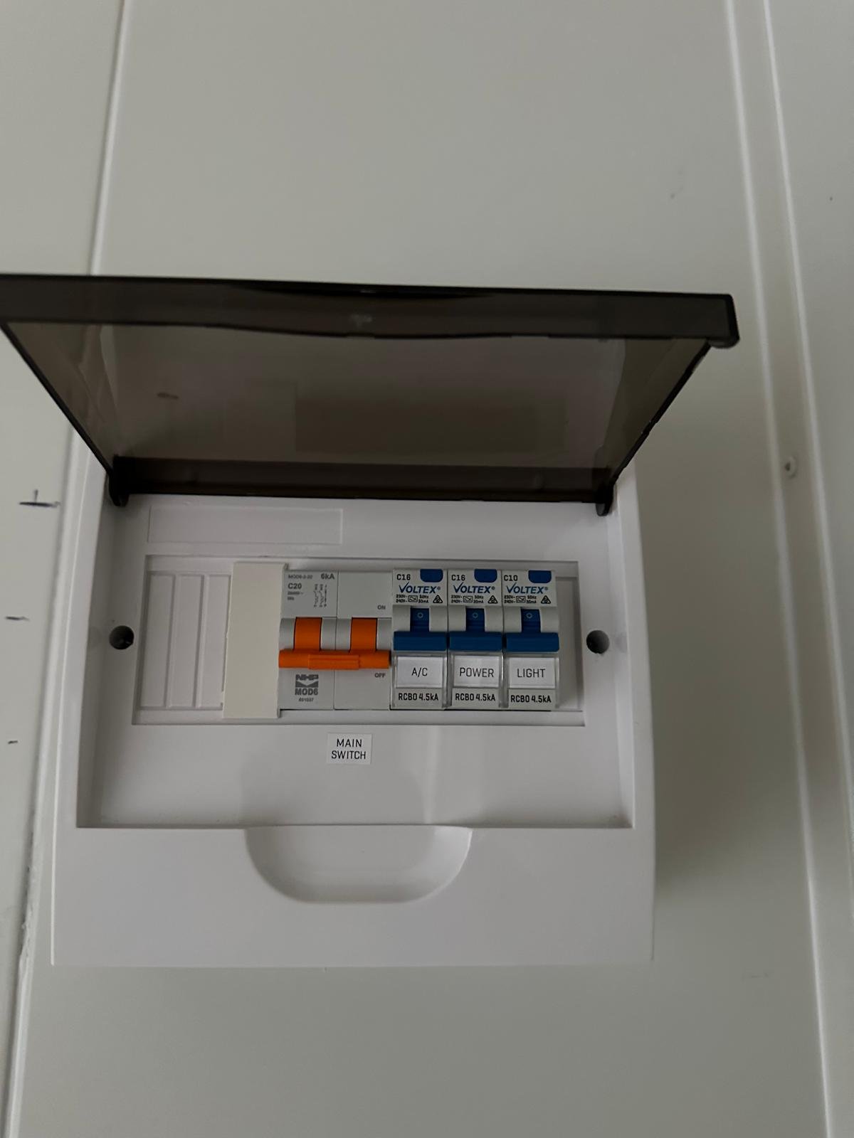 Compact residential switchboard with labelled main, air conditioning, power and lighting circuits
